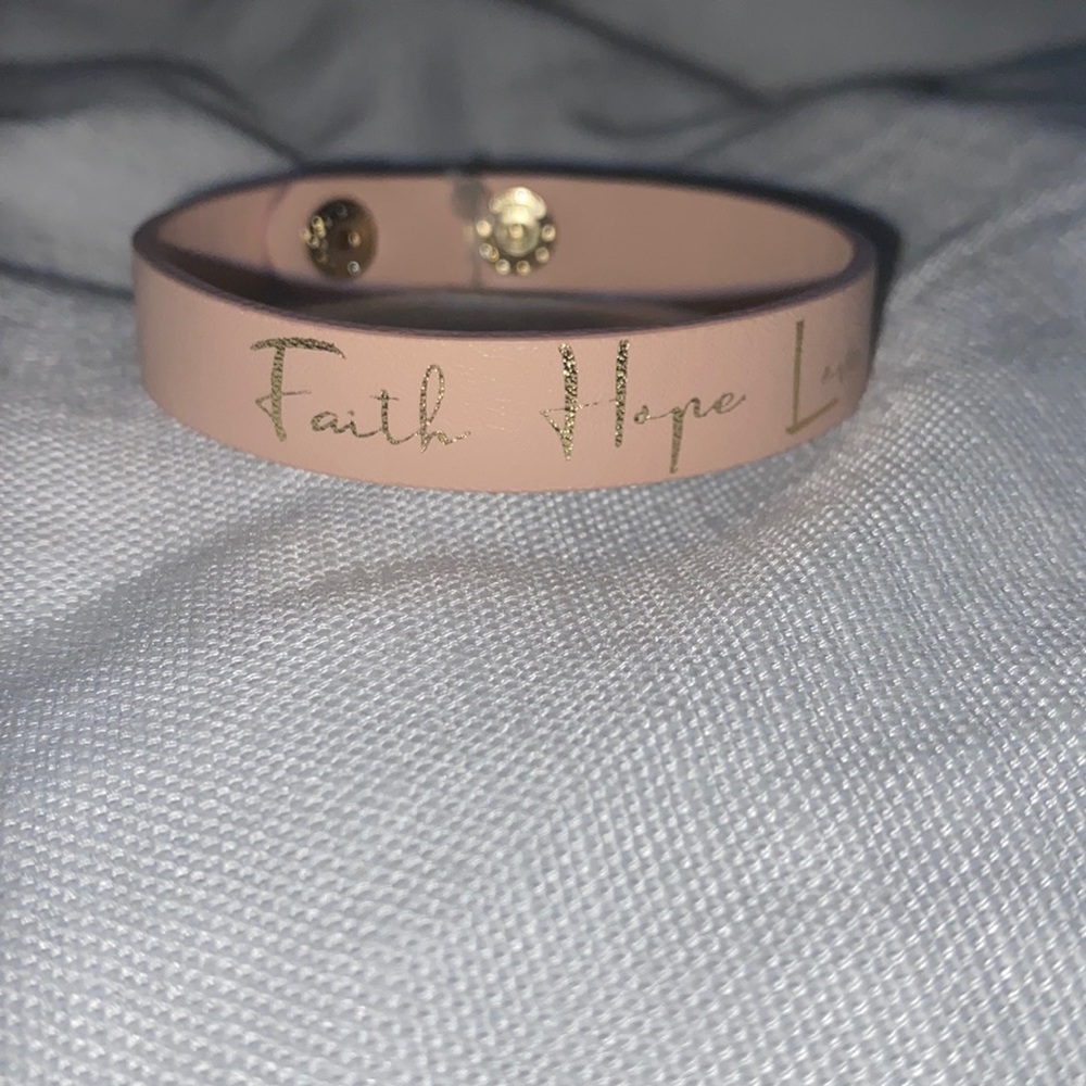 Kids pink adjustable bracelet with gold words.